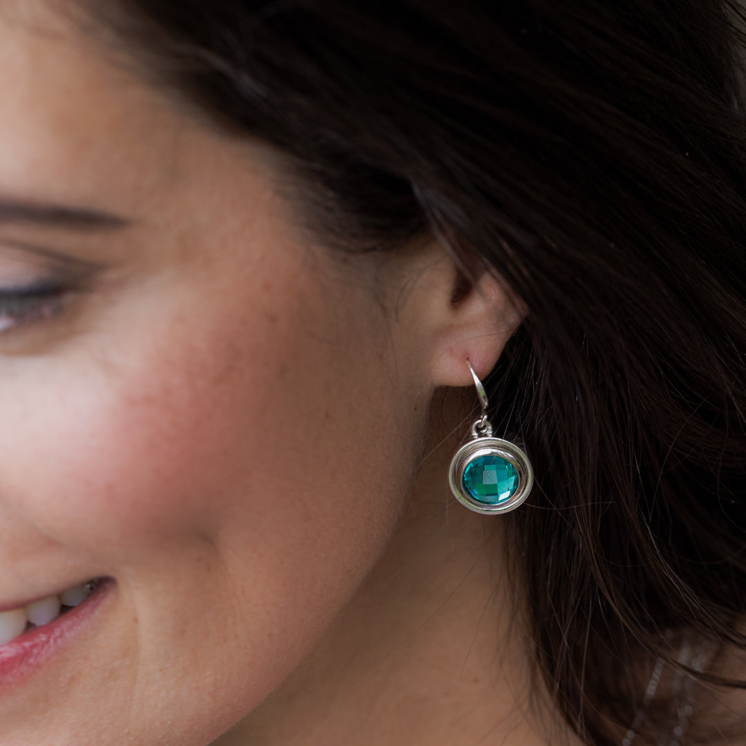 Silver hook earrings with teal solitaire crystal pendant center