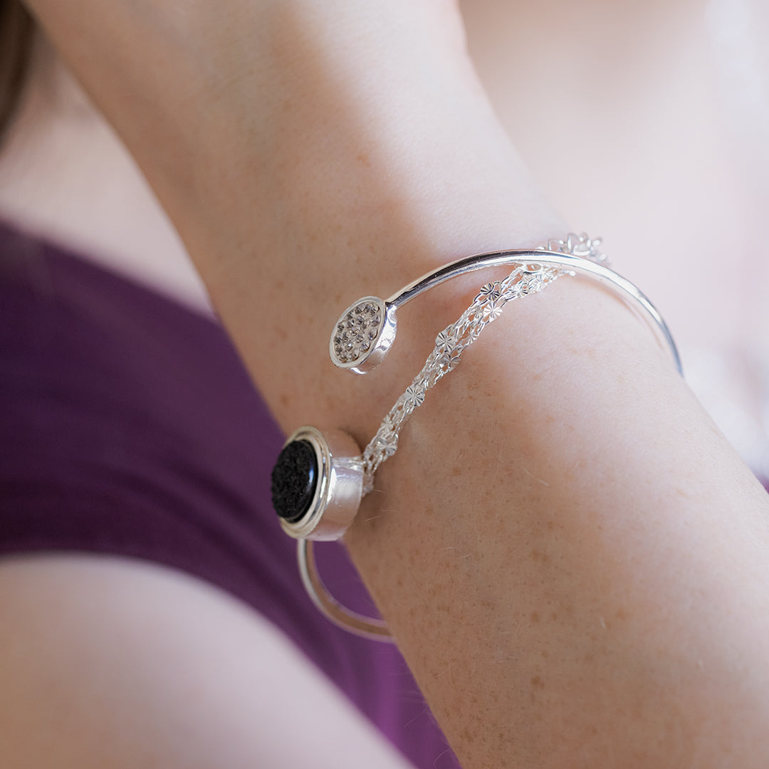 Layered bracelets in silver and crystals