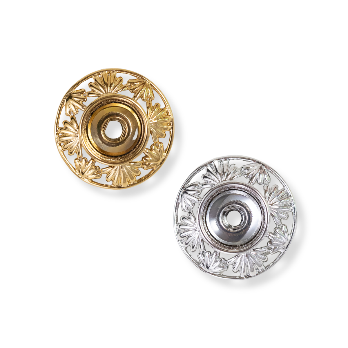 In the photograph, a silver and gold Chloe Pendant sits in the middle of a white background. Delicate openwork design with sculpted fans around the pendant. The Chloe pendant is customizable, pairs perfectly with a Style Dots interchangeable Original Dot in the middle of the pendant. 
