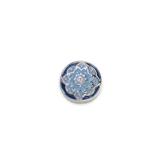 On a white background, the photo has a single dotlet in the middle of the graphc. The Dotlet is a Denim Petaline Dotlet with  dark blue border and light blue in the middle flowers set in silver