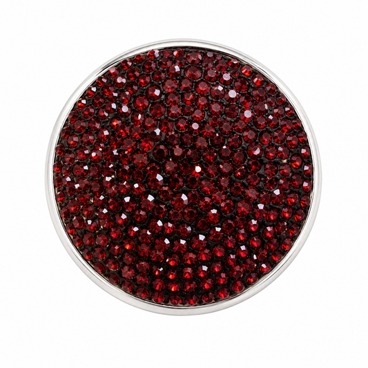 A round silver-toned bezel setting filled with small, faceted deep red gemstones, presented on a solid white background.