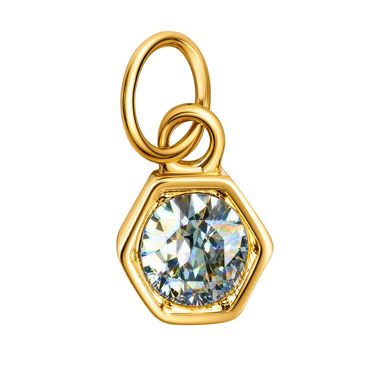 A gold hexagonal pendant charm featuring a large, round-cut clear gemstone in a prong setting, shown on a plain white background.