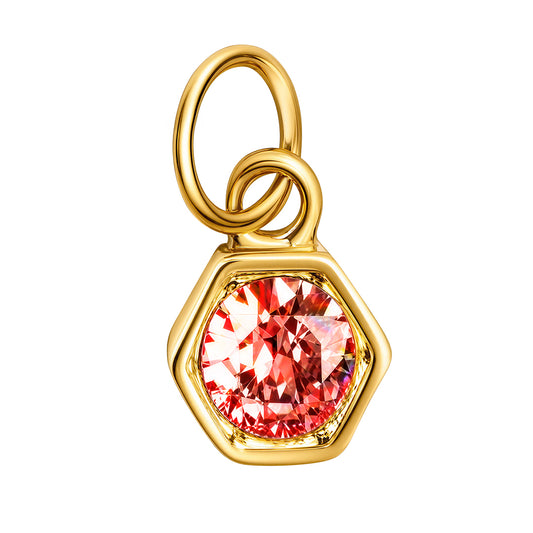 A gold hexagonal pendant charm featuring a large, faceted pinkish-red gemstone, shown on a solid white background.