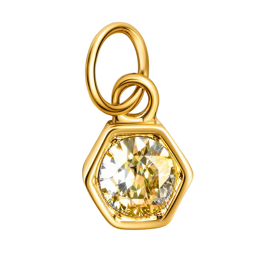 A gold hexagonal pendant charm featuring a large, faceted yellow gemstone in a prong setting, complete with a double-loop bail at the top, shown on a plain white background. 