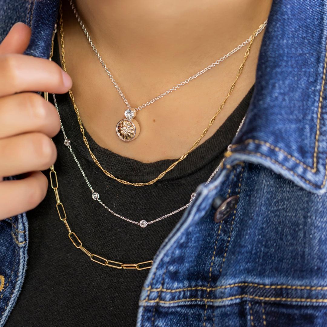 Layering jewelry with mix and match silver and gold necklaces