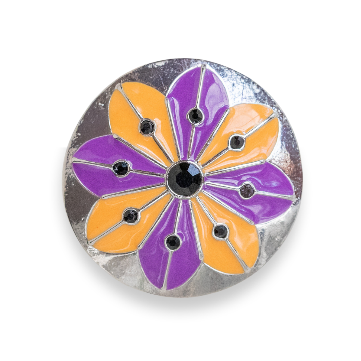 A round silver-tone dot featuring a stylized flower design with alternating purple and orange enamel petals, divided by thin metallic lines, with a central black faceted gemstone.