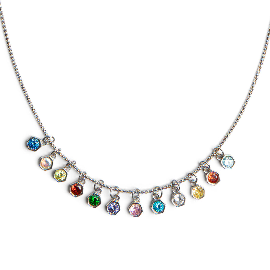 A silver-toned necklace featuring a curved chain with multiple small dangling charms, each set with a different colored faceted gemstone, shown on a plain white background.