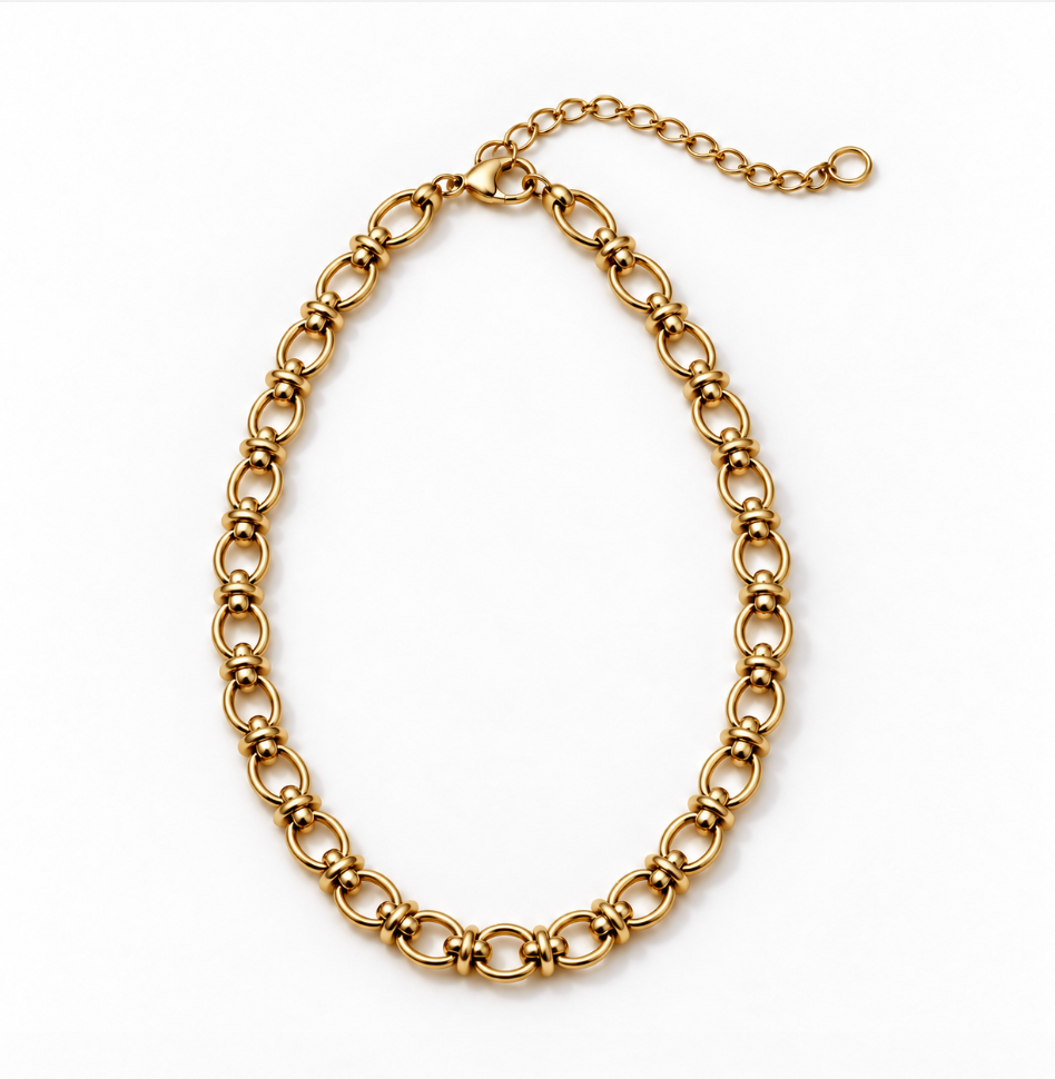 A gold-toned metal link chain necklace with elongated oval links and a short extender chain with a clasp, photographed on a plain white background.