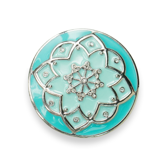 A round turquoise and mint green enamel button with a silver-tone floral mandala design and small clear rhinestones, shown on a white background.