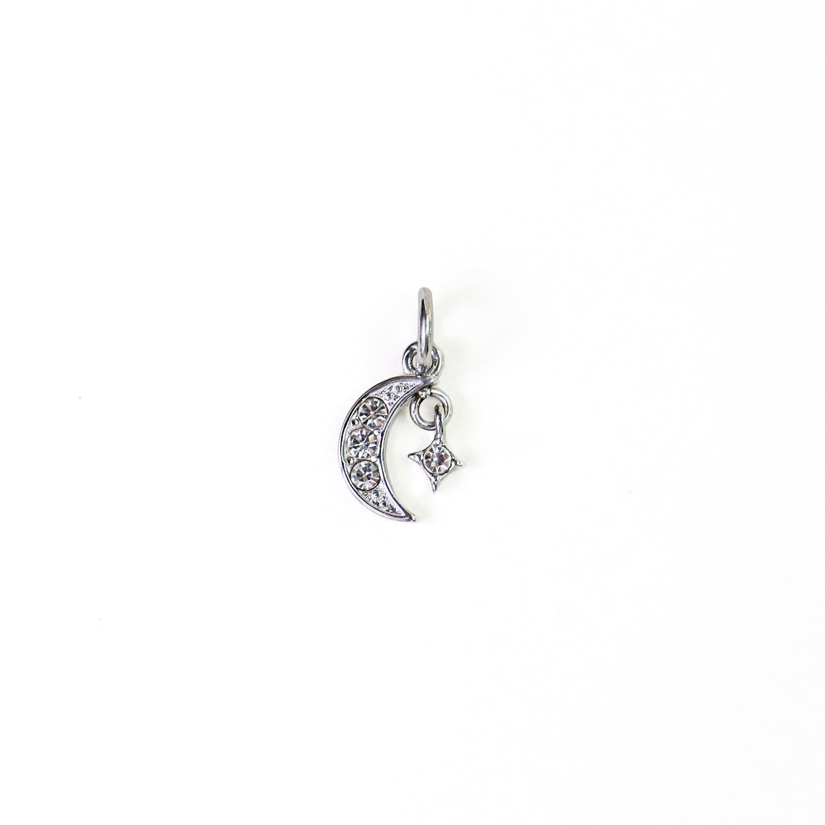 A silver crescent moon and star charm, embellished with clear rhinestones, shown on a plain white background.