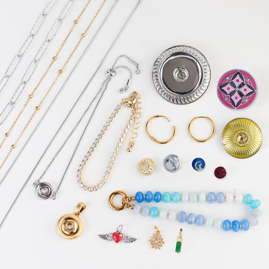 A flat-lay collection of various jewelry items, including necklaces, bracelets, rings, and earrings, arranged on a clean white background.