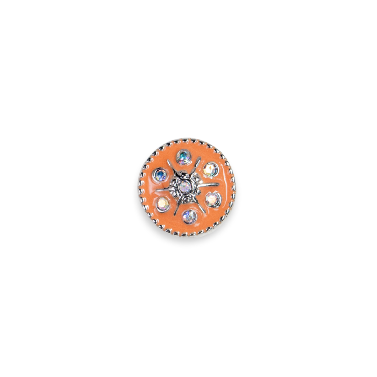 A round orange enamel pin with a silver-tone metal border and a central floral starburst design featuring clear rhinestones. The middle looks like a little sun with crystals embedded between the silver sunburst lines. 