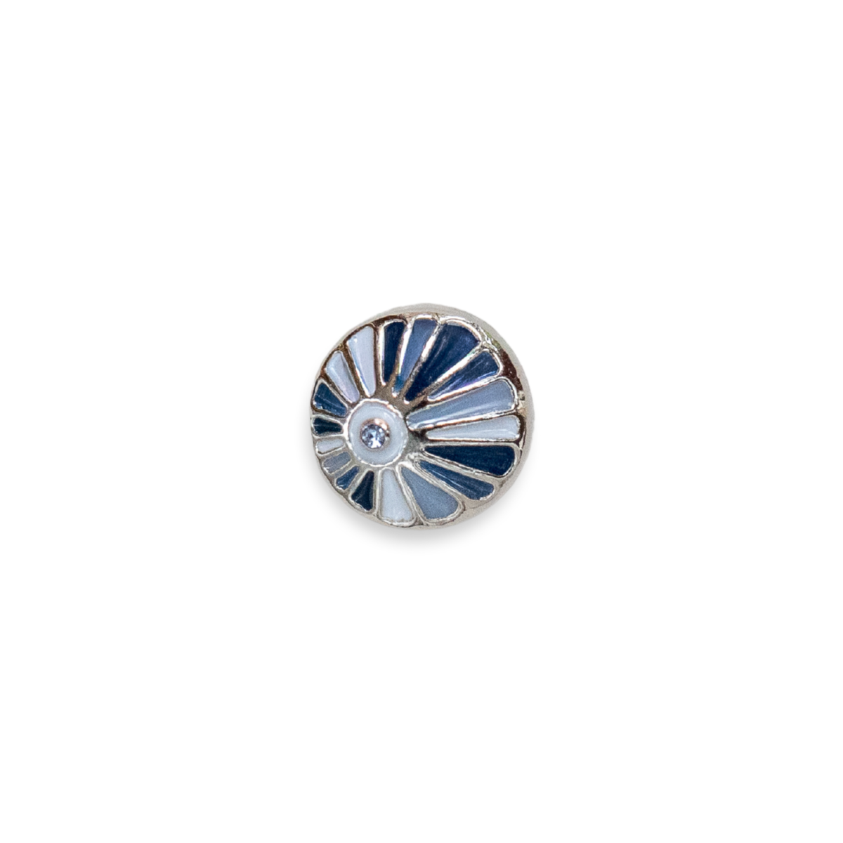 A round silver-toned Dotlet, featuring a sunburst pattern with alternating light blue, navy blue, and white enamel segments, centered with a small clear rhinestone.