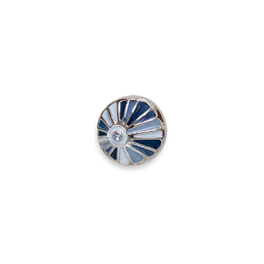 A round silver-toned Dotlet, featuring a sunburst pattern with alternating light blue, navy blue, and white enamel segments, centered with a small clear rhinestone.