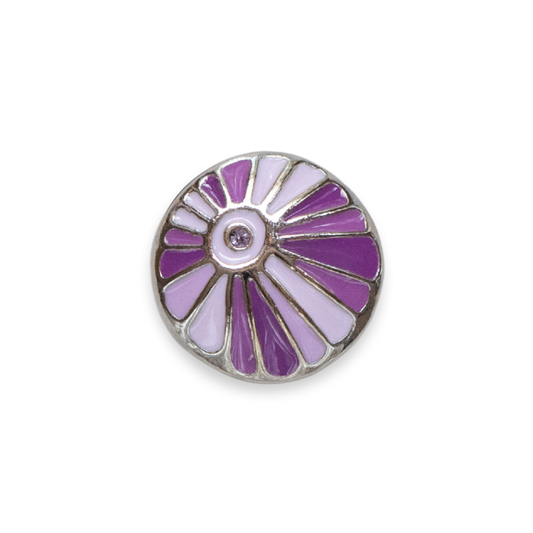 A round silver-tone Dot, featuring a fan sunburst design with alternating purple and light lavender enamel sections, and a small clear rhinestone in the center, shown on a plain white background.