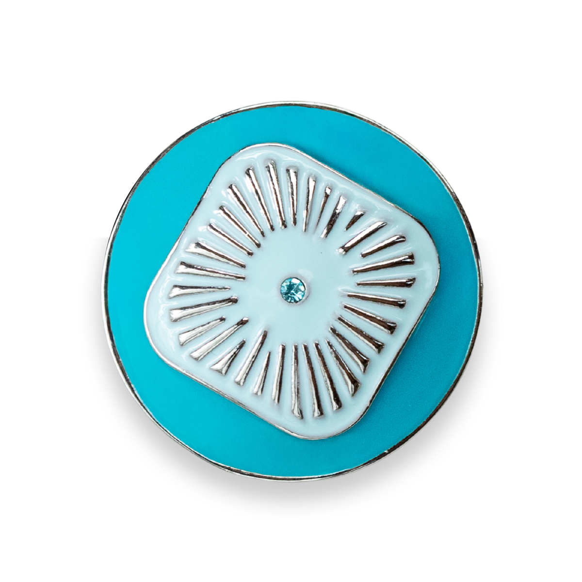 A round turquoise blue enamel Dot with a central light blue square design featuring radiating silver metal lines and a small blue crystal in the center, shown on a white background.