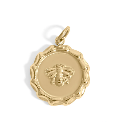 A round gold pendant charm featuring a raised bee motif in the center and a scalloped outer edge, shown on a plain white background. A stamp charm