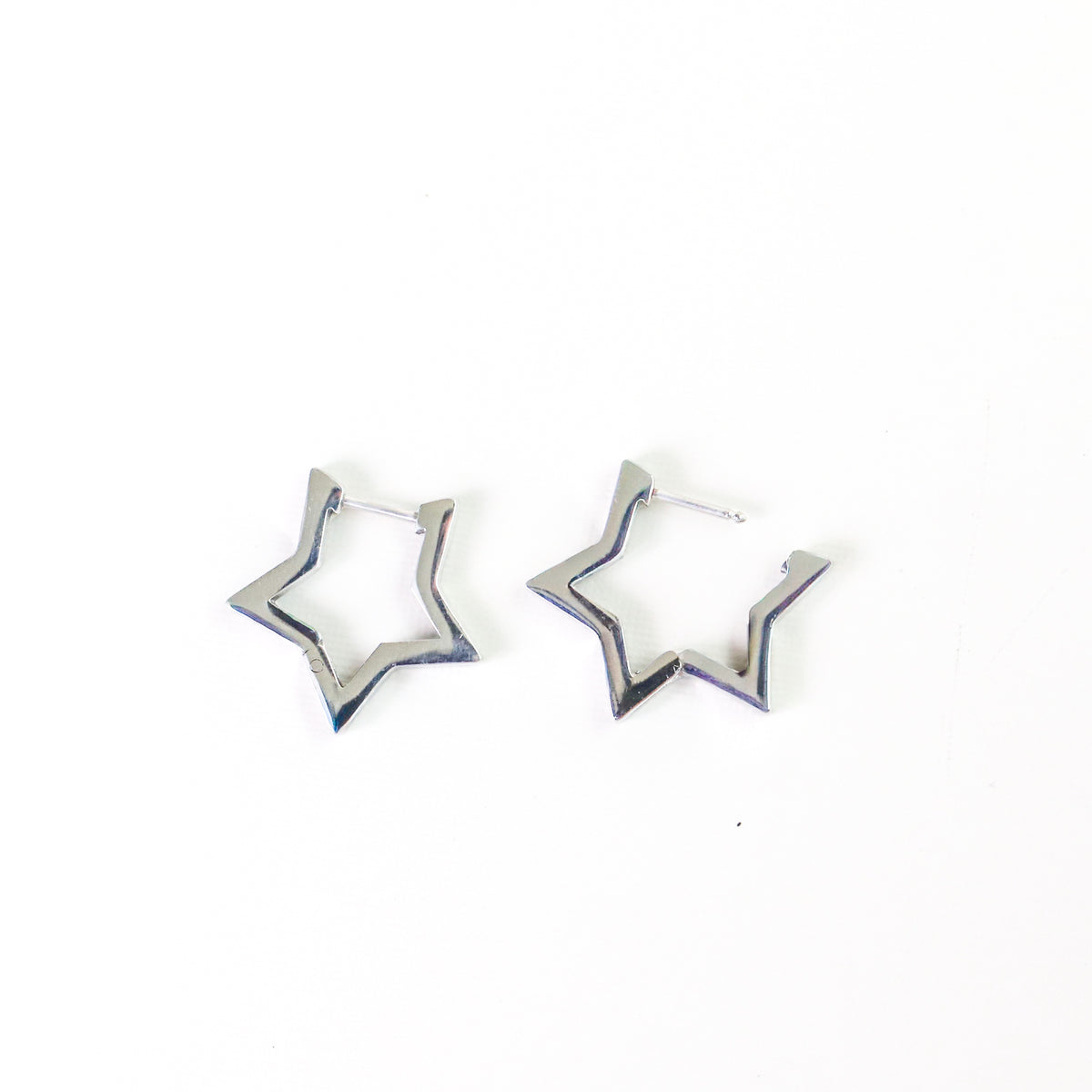A pair of silver-toned open star-shaped hoop earrings on a plain white background.