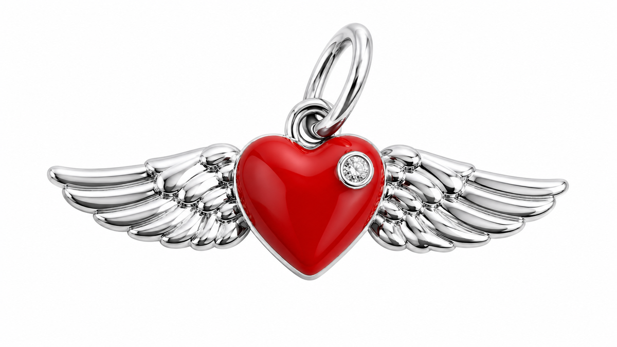 A silver angel wing pendant featuring a glossy red heart in the center with a small clear crystal accent, set against a plain white background.